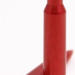 Two red lipstick bullets in a white studio background, one standing upright and the other lying on its side, showing the pointed tip.