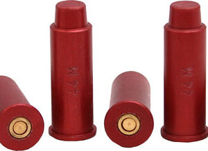Five red shotgun shells on a white background, some upright and some lying on their sides with brass primers visible.