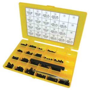 Opened yellow plastic parts kit with many small black components and a metal tool; lid features a printed grid of instructions or chart.