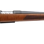 Bolt-action hunting rifle with a polished wooden stock and long black barrel, shown from the left side.