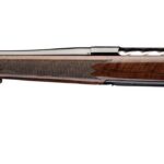 Bolt-action rifle with a polished wooden stock and long blued barrel, shown from the side.