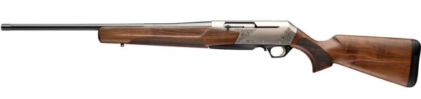 Side profile of a long, engraved sporting rifle with a wooden stock and silver-toned receiver on a white background.