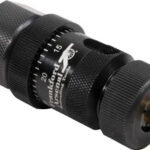 Close-up of an adjustable torque screwdriver with a knurled black metal body and brass tip holder, used to apply precise torque to fasteners.