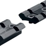 Two black rail-mount blocks with ridged surfaces and screw holes, likely used to attach firearm accessories.