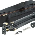 Carbon fiber travel tripod with a padded carrying case and all accessories (quick-release plate, center column, leg sections, Allen key).