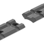 Two gray LEGO Technic-style connector pieces with central circular holes and stepped ridges, viewed from above.