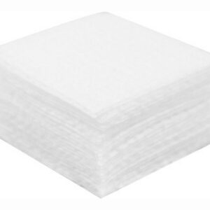 Stack of white paper napkins folded into neat squares, forming a cube-like block