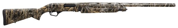 Camouflage hunting shotgun with long barrel and pistol grip.