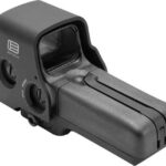 Compact red-dot reflex sight with side adjustment dials mounted on a base, designed for firearms.