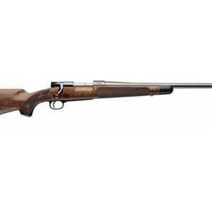 Bolt-action rifle with a wooden walnut stock and long steel barrel, facing right.