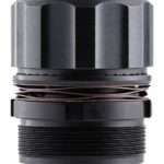 Close-up of a metal cylindrical component with a copper coil winding around the middle and a threaded bottom portion.