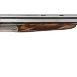Side-by-side double-barrel shotgun with walnut stock and engraved receiver, shown in profile with metal barrels gleaming.