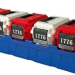 Row of four red tool storage boxes with black numbered plates reading 1776, placed in a blue plastic organizer tray.