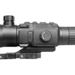 Black tactical rifle scope mounted on a rail, showing adjustment knobs and ribbed eyepiece for aiming