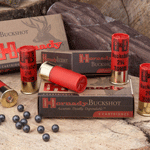 Assorted Buckshot shotgun ammunition boxes with red shotgun shells arranged on a wooden surface.