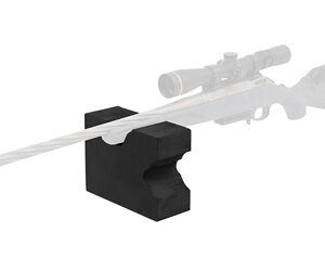 Rifle with scope resting on a black front shooting rest on a white background.