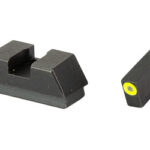 Pair of black, angular plastic sights: a larger rear sight with a central notch and a smaller front sight featuring a yellow end cap.