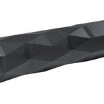 Black, faceted cylindrical tool or grip with a hexagonal socket opening at one end.