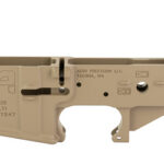 Tan AR-15 lower receiver component with magwell and trigger area; markings show model X15, cal multi, by Aero Precision LLC, Tacoh WA (gun part)