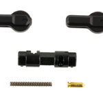 Set of small black mechanical parts: two levers, a central connector, a coil spring, and a gold pin.