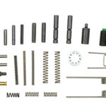 Assorted small metal springs, pins, rods, spacers, and clips laid out on a white background.