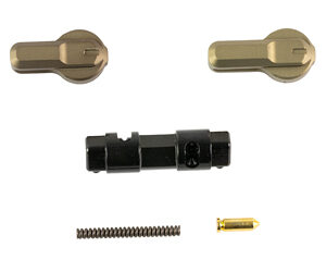 Assorted tiny hardware parts: two brass pieces, a black plastic connector, a coil spring, and a small gold pin.