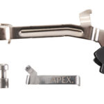 Disassembled SRAM Apex bicycle brake/shift lever components: curved metal lever, small pin, branded connector piece, and black trigger housing on white background.