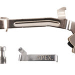 Curved metal handheld tool with jaws and a trigger, accompanied by a small pin and a metal clip labeled APEX.