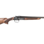 Single-barrel shotgun with a wooden stock and ornately engraved metal receiver.