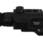 Black compact riflescope with rubber eyepiece and adjustable turrets, labeled THOR 6 mini 2.5–20x, mounted on a rail.