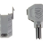 Pair of gray plastic toy accessories: a hollow clip on the left and a shield-shaped piece with a logo and stem on the right, likely attachments for a figure.