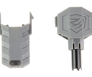Pair of gray plastic toy accessories: a hollow clip on the left and a shield-shaped piece with a logo and stem on the right, likely attachments for a figure.