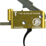 Gold TriggerTech rifle trigger assembly with side lever and BAD Edition label, shown with a black cable and patent text on the body