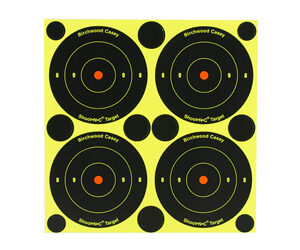 Sheet of four black bullseye targets with orange centers on a bright yellow background.