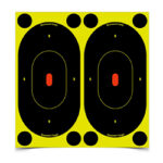 Two black oval shooting targets with orange centers mounted on a bright yellow backing.