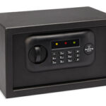 Black electronic safe with a numeric keypad lock and indicator lights for securing valuables