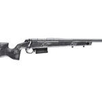 Bolt-action rifle with a long barrel and detachable magazine, mounted on a dark stock.