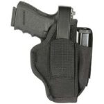 Black handgun seated in a belt holster with a retention strap and magazine pouch on the side