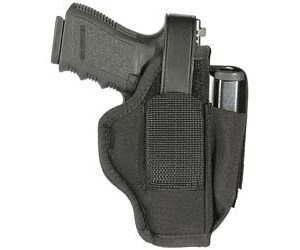 Black handgun seated in a belt holster with a retention strap and magazine pouch on the side