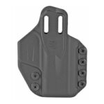 Black polymer pistol holster with adjustable retention screws and belt-clip slots, designed to hold a handgun.
