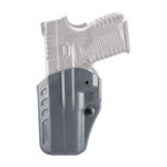 Semi-automatic pistol tucked into a gray holster with the grip showing.