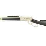 Profile view of a beige-and-black pump-action shotgun with a long barrel and black stock.