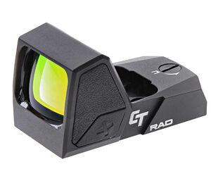 Compact black red-dot sight with a green-tinted lens mounted on a rifle rail.