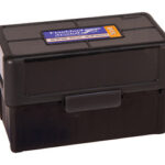 Black plastic storage box with a latch, rectangular and compact, with a label on the lid.