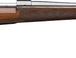 Bolt-action hunting rifle with a wooden stock and long steel barrel on a white background.