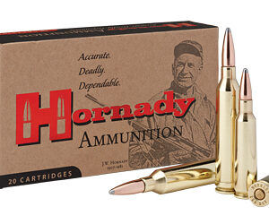 Hornady ammunition box with several brass rifle cartridges leaning against it; highlights the brand name and 20 cartridges in the package.