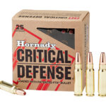 Box of Hornady Critical Defense handgun ammo with three rounds standing upright and one cartridge lying flat beside it.