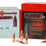 Two red Hornady Varmint ammunition boxes with several bullets laid out in front; the left box shows 'Qty: 100'.