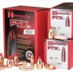 Red display boxes labeled FTX ammo with several brass bullets arranged in front, showcasing the product packaging.