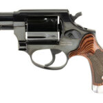 Compact revolver handgun with a black metal frame and checkered wooden grip on a white background
